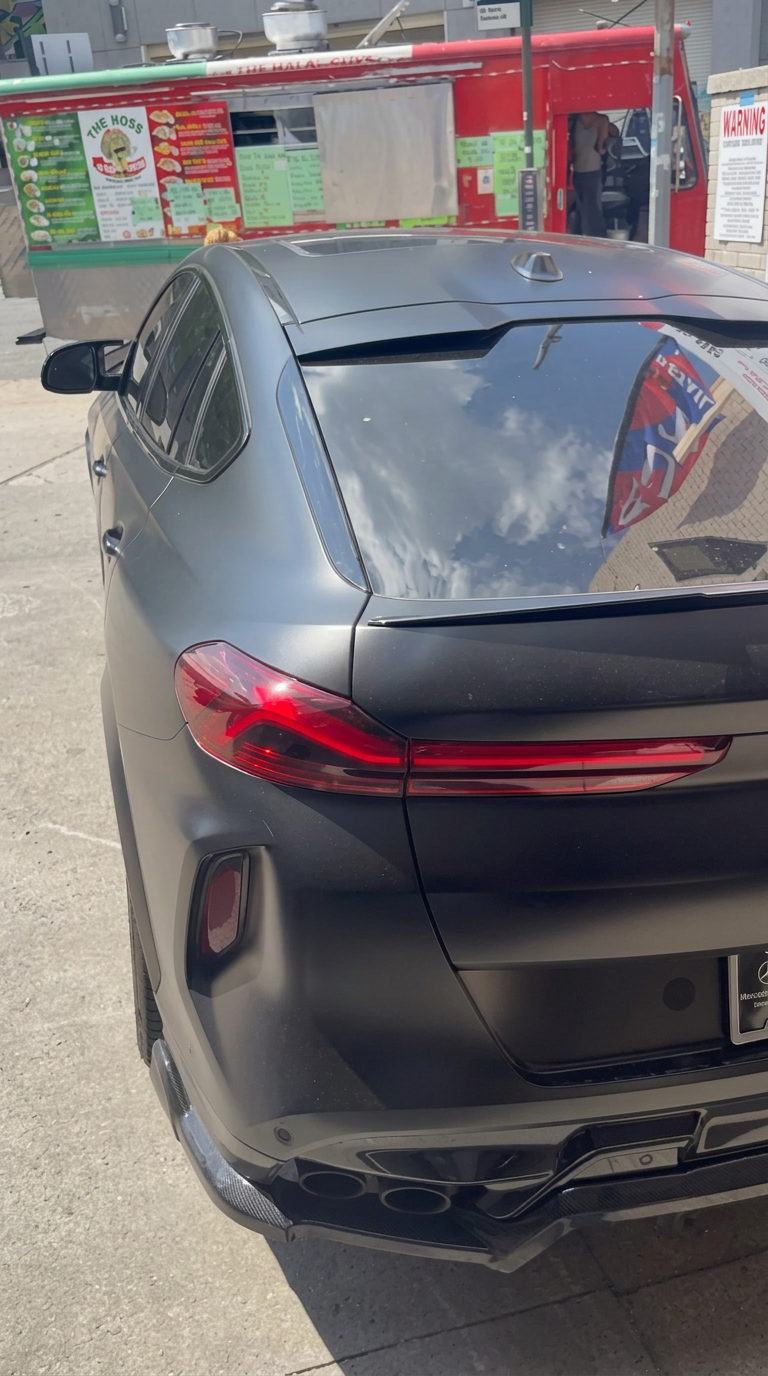 Rear of a matte black BMW X6 M after detailing