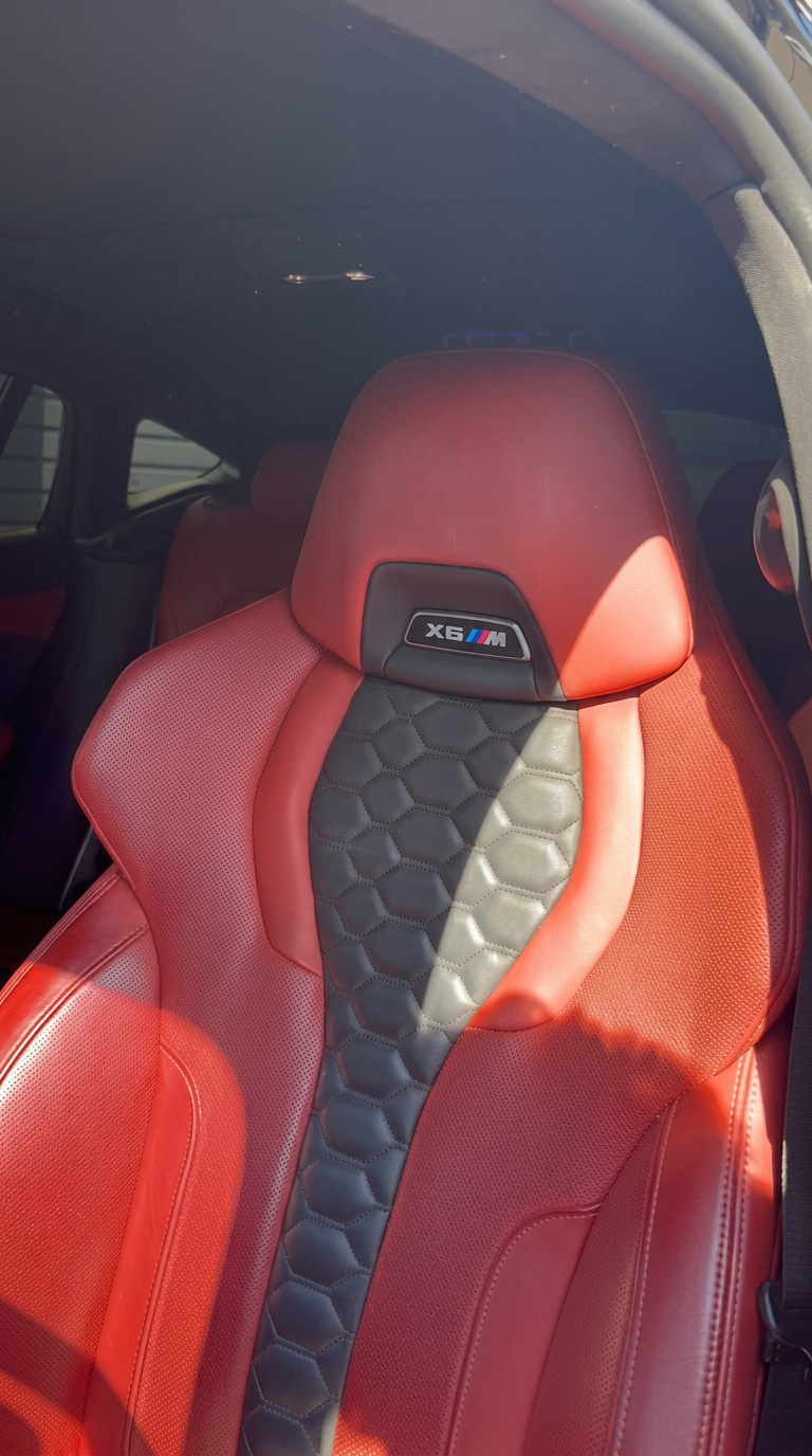 Red leather BMW X6 M seat cleaned and conditioned